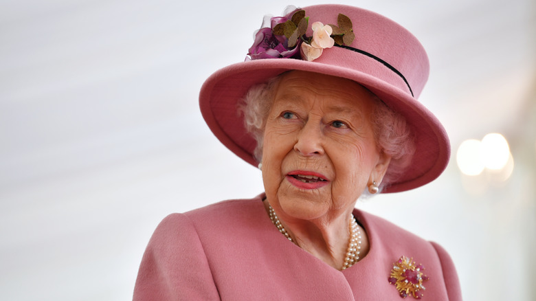 Queen Elizabeth II in a pink hat and jacket
