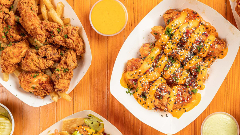 Variety of different chicken options from Sticky's on wooden table