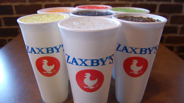 Seven Zaxby's soda cups in a circular formation sit on a countertop