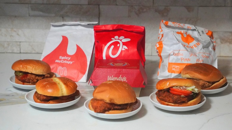 Lineup of fast food chicken sandwiches pictured.