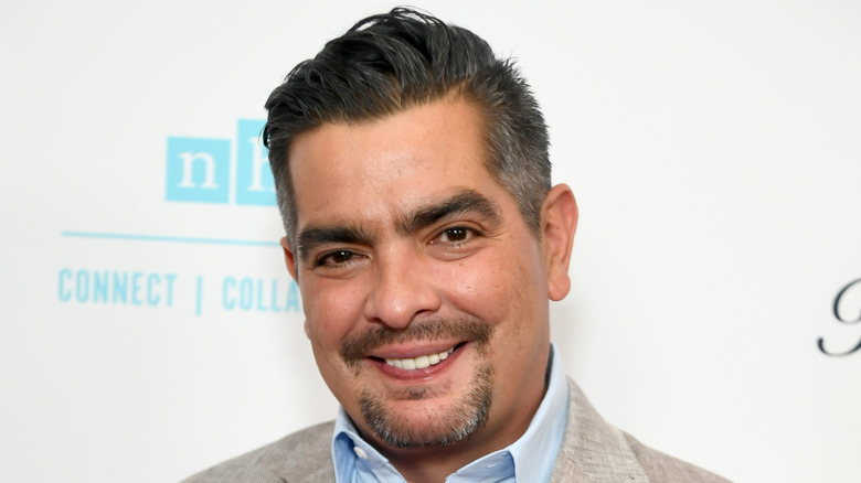 Aarón Sànchez in front of step and repeat