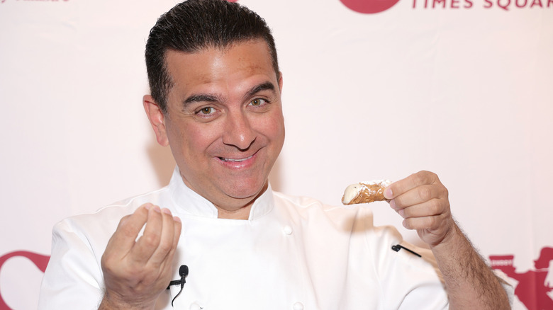 Buddy Valastro posed in front of Carlo's Bakery step and repeat