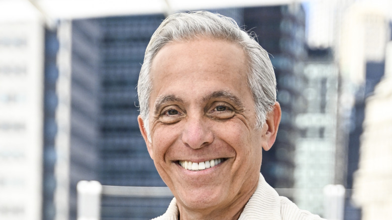 Geoffrey Zakarian posed outdoors in front of buildings