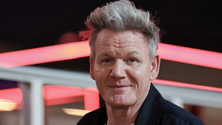 Gordon Ramsay in front of glowing red lights