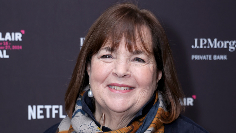 Ina Garten posed in front of step and repeat