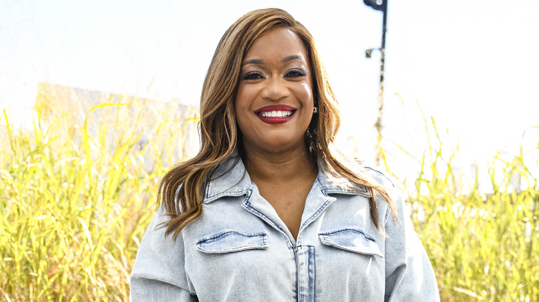 Sunny Anderson posed outside in front of tall grass
