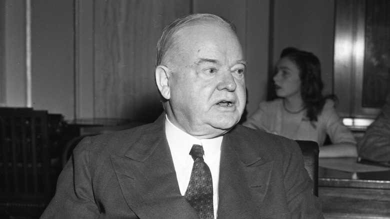 Black and white portrait of U.S. President Herbert Hoover seated in a chair