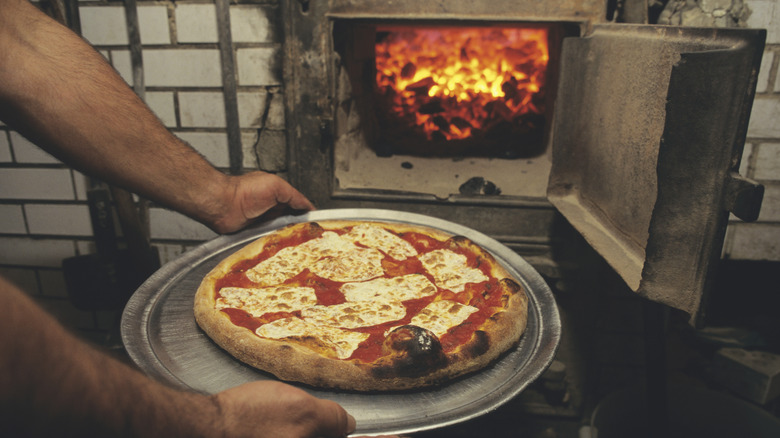 Pizza cooked in brick coal-burning oven at Lombardi's pizzeria