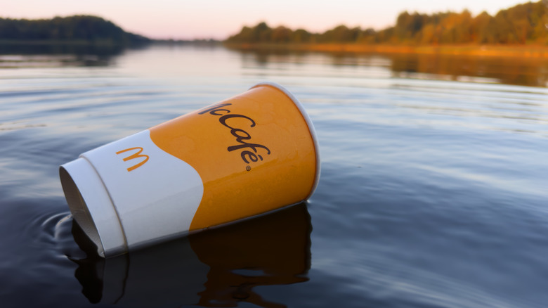 A McCafé cup floating in water.