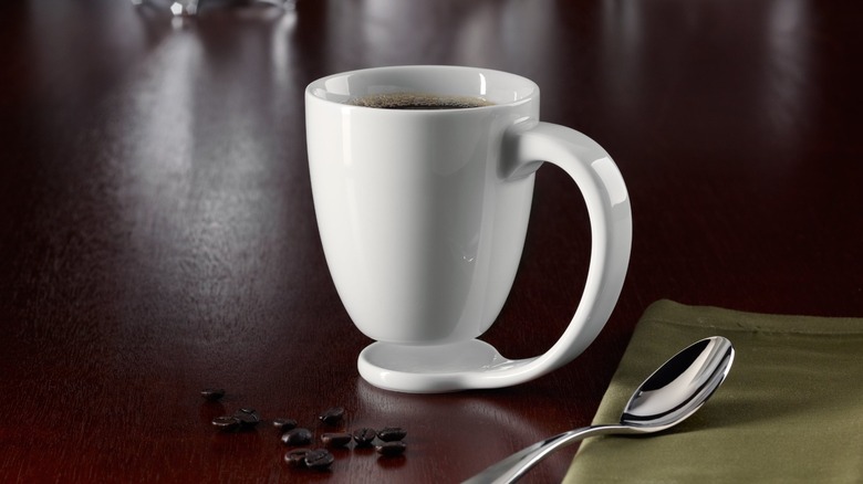 Floating Mug on table next to spoon