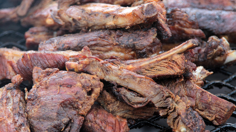 Barbecued meat on a grill.