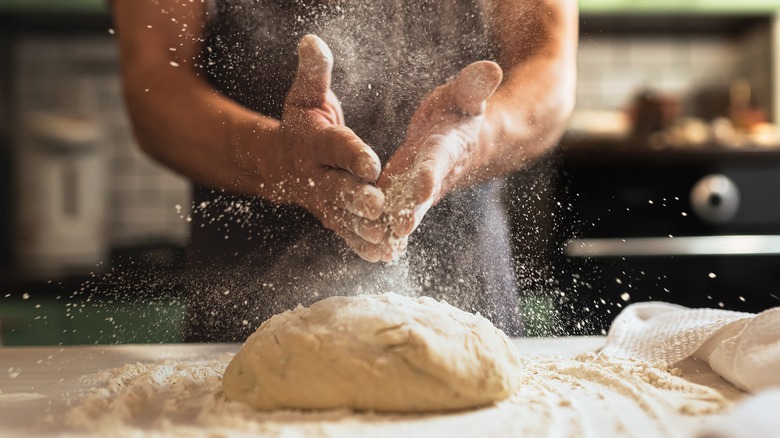 Hands dough flour