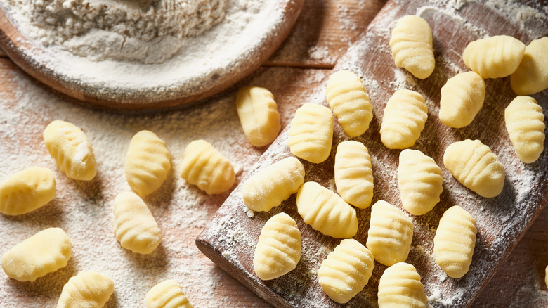 Homemade gnocchi on a flour-dusted cutting board