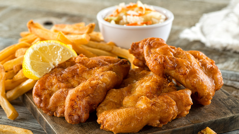 Crispy fried fish fillets with french fries and coleslaw