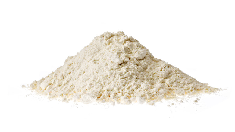 Heap of flour on white background