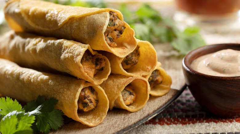 taquitos with sauce and cilantro