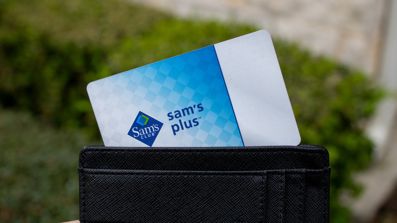 A Sam's Club Plus membership card sticking out of a black wallet