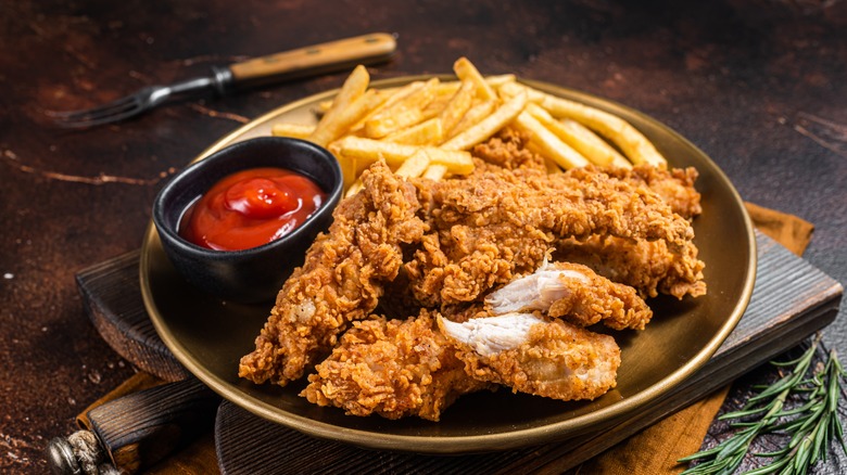 fried chicken tenders with fries and ketchup