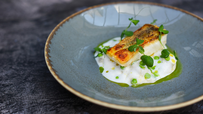 A fish filet on top of potato puree