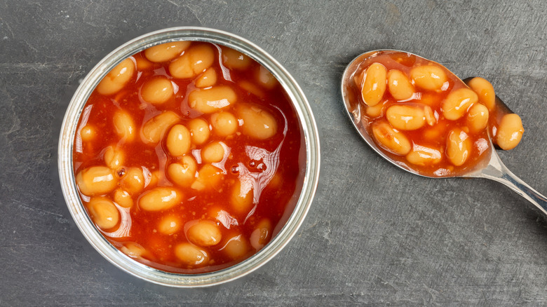 Can of baked beans pictured with a spoon.