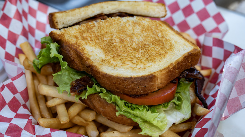 BLT sandwich in basket with fries