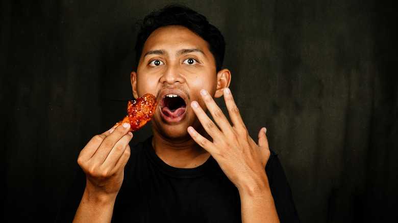 Someone eating some spicy chicken and not having a good time