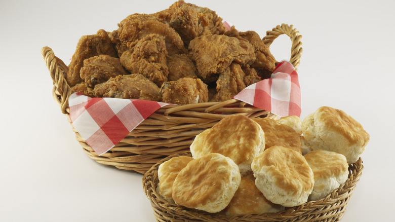 a basket of fried chicken and a basket of biscuits