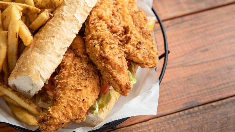 Chicken tenders in a bun with a side of fries