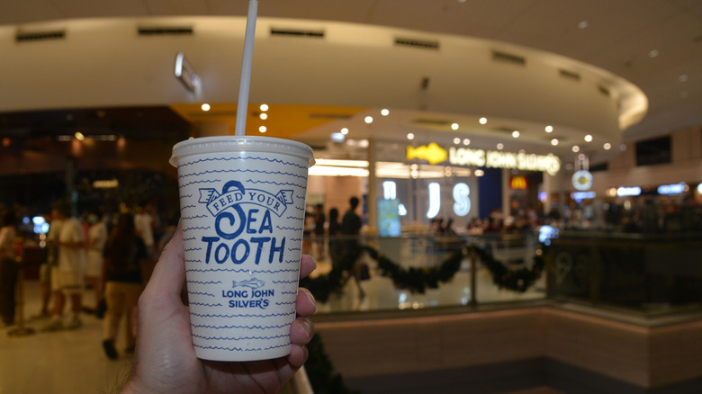 A hand holding a Long John Silver's cup.