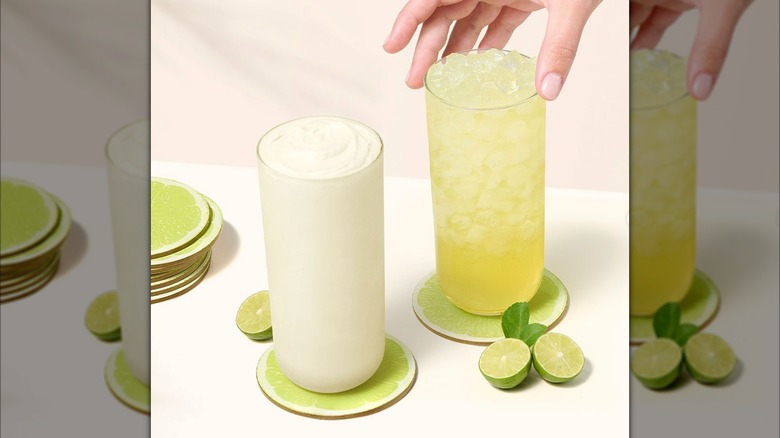Chick-fil-A's Frosted Key Lime Lemonade and Key Lime Lemonade on lime coasters with fresh limes