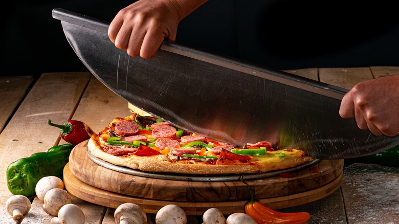 Large Mezzaluna cutting pizza