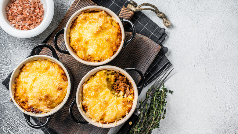 Three mini Shepard's Pies in casserole dishes.
