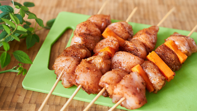 Raw chicken on skewers