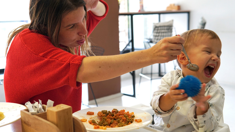 kid crying at at dinner with mom