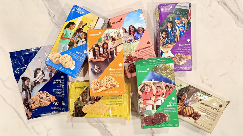 A collection of Girl Scout Cookie boxes on a counter