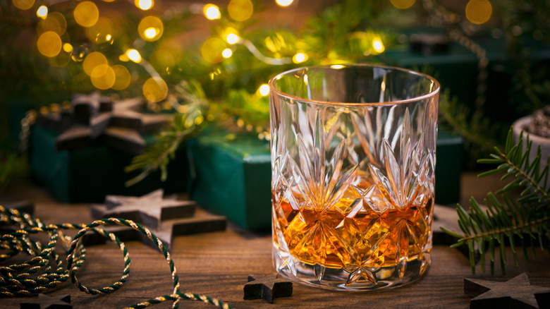 A glass of bourbon in a festive setting.