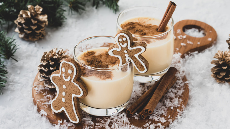 Glasses of eggnog with gingerbread men.