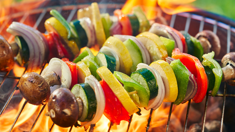 Kabob skewers cooking on a grill