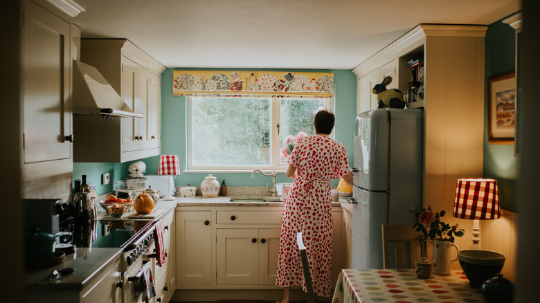 Old school kitchen with a woman looking out the window