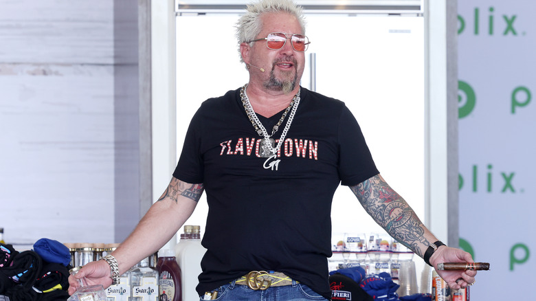 Guy Fieri speaks to a crowd at the 2024 South Beach Wine & Food Festival