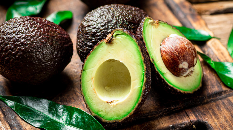 Sliced avocados on wooden table