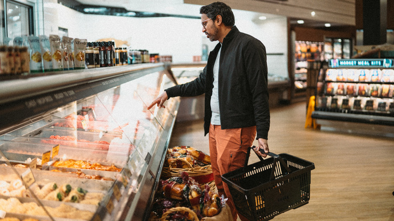 Man at grab-and-go counter in grocery store