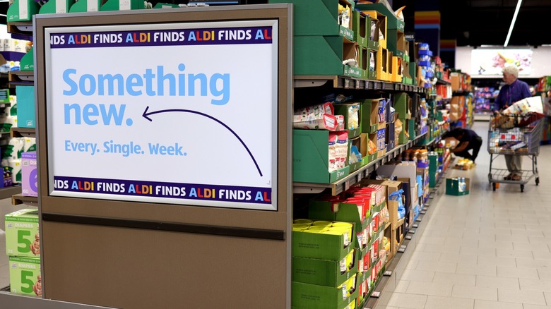 An sign that reads "Something new. Every. Single. Week." inside an Aldi grocery store