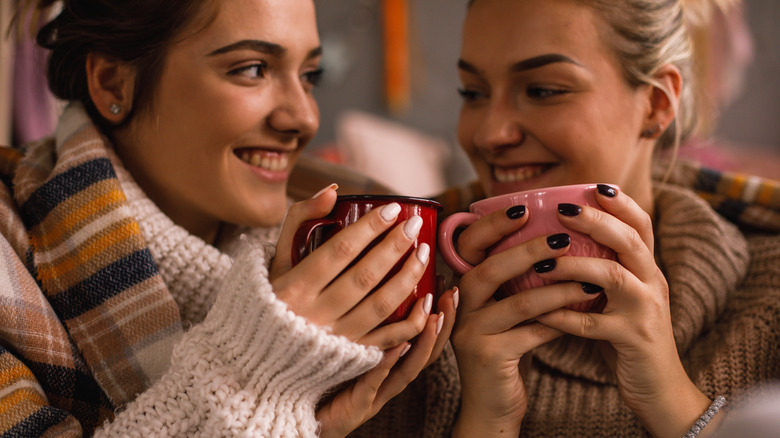 happy women holding mugs