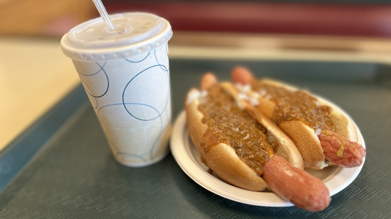 Two Texas wieners on a plastic tray with a soda