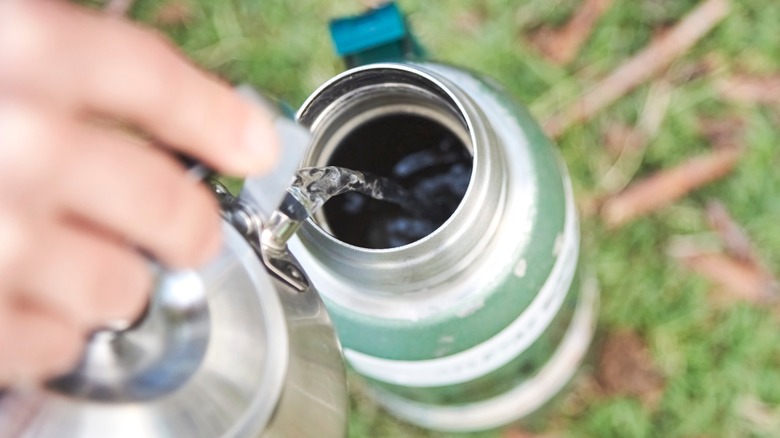 Pouring hot water into thermos