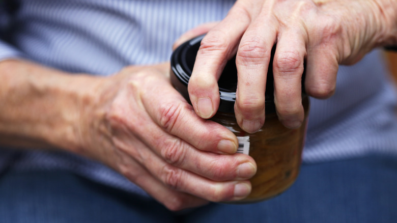 Person trying to open jar