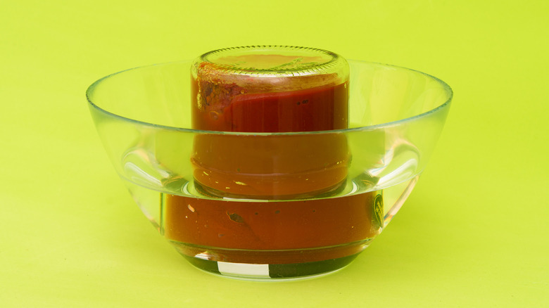 Jar upside down in bowl of hot water
