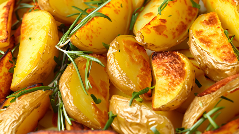 Roasted potatoes appear crispy and are sprinkled with rosemary