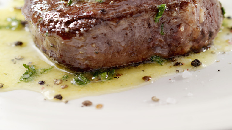A medium-rare filet mignon with compound butter